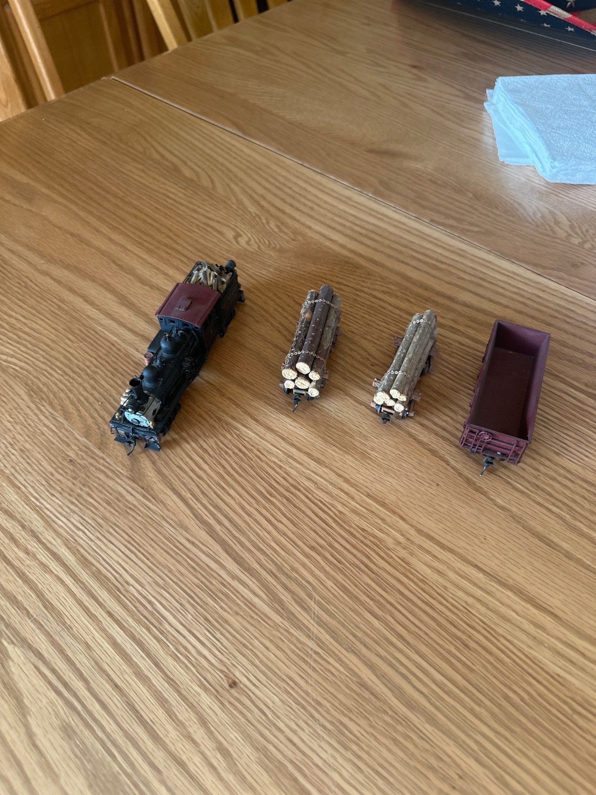 two truck pacfic fast mail shay with 2 weathered log cars and a gondola car