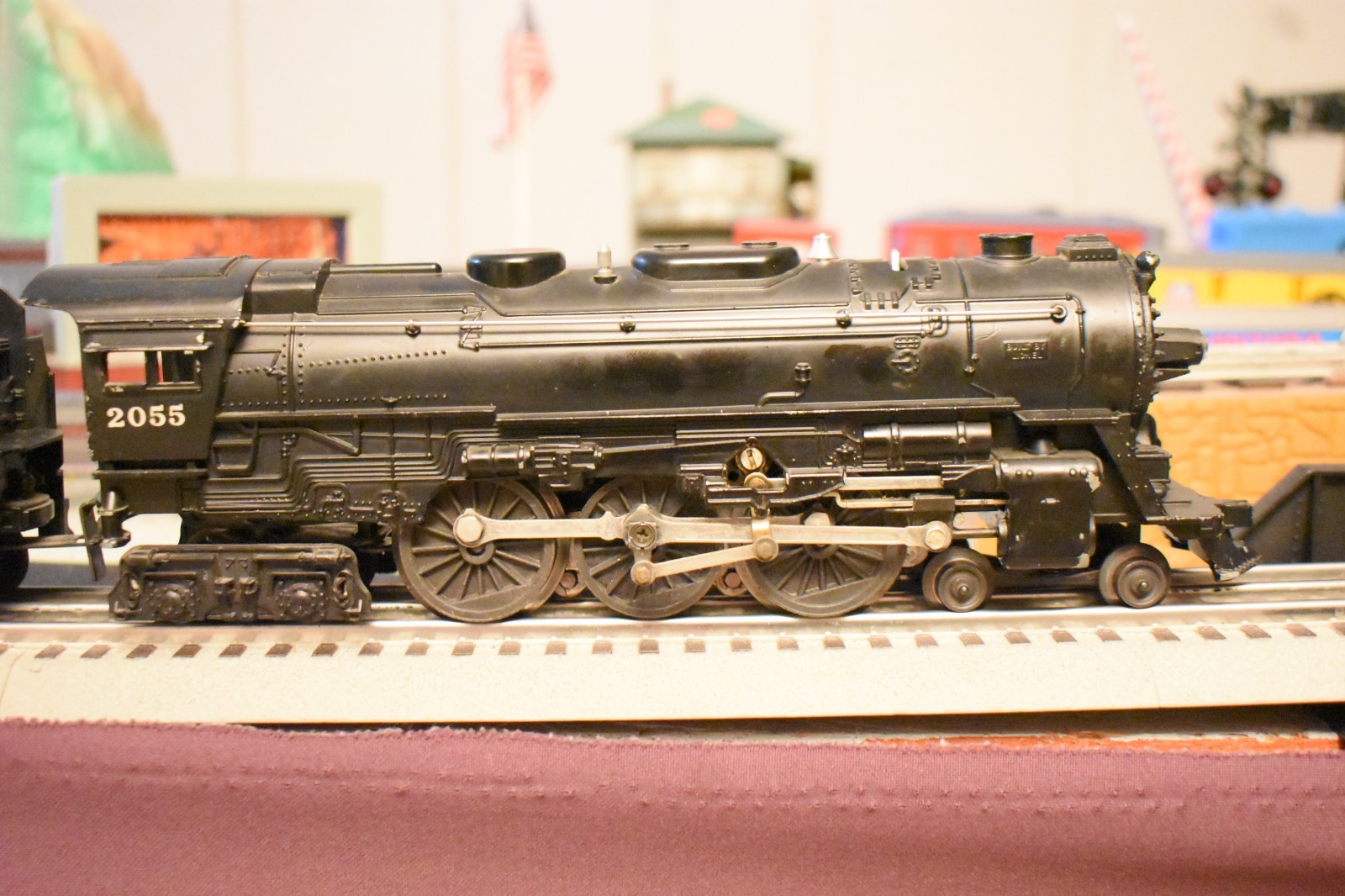 Lionel 2055 steam locomotive & 6026W Tender and 3 rolling stock cars.