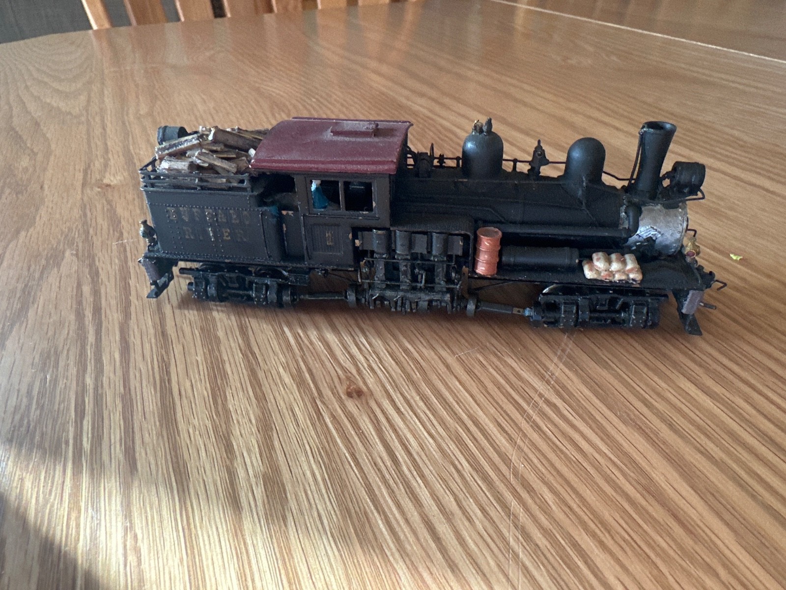 two truck pacfic fast mail shay with 2 weathered log cars and a gondola car