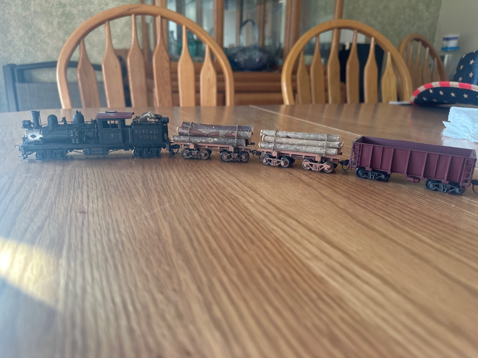 two truck pacfic fast mail shay with 2 weathered log cars and a gondola car