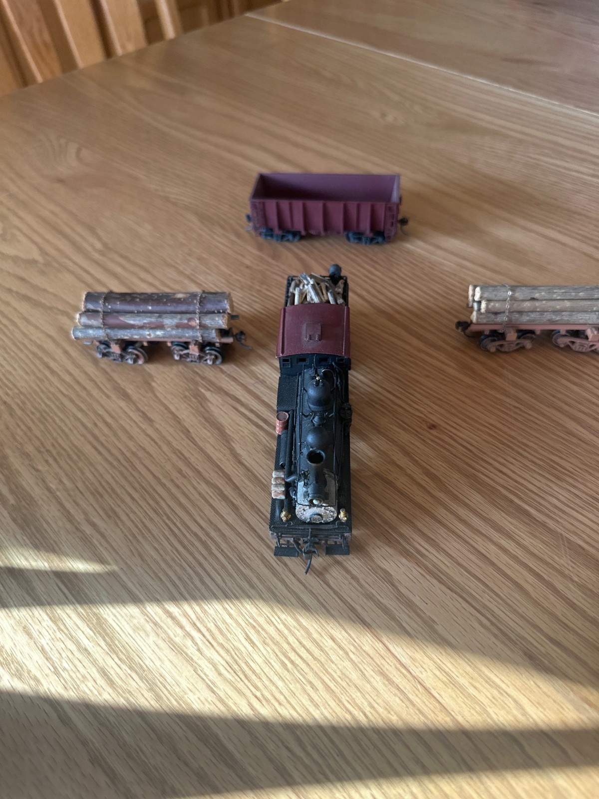 two truck pacfic fast mail shay with 2 weathered log cars and a gondola car