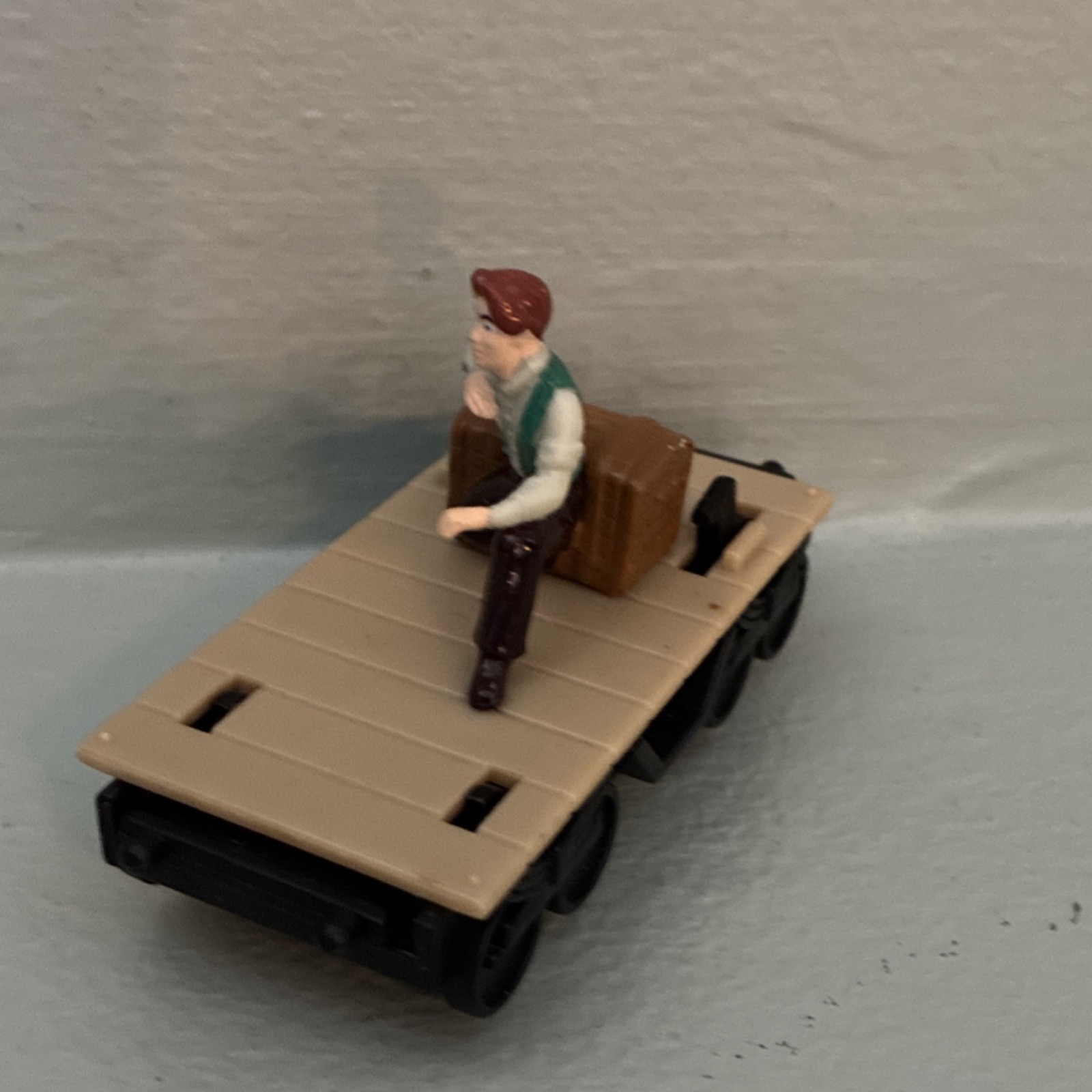 Model Railroad Locomotive Flat Car with Seated Figure and Brown Box
