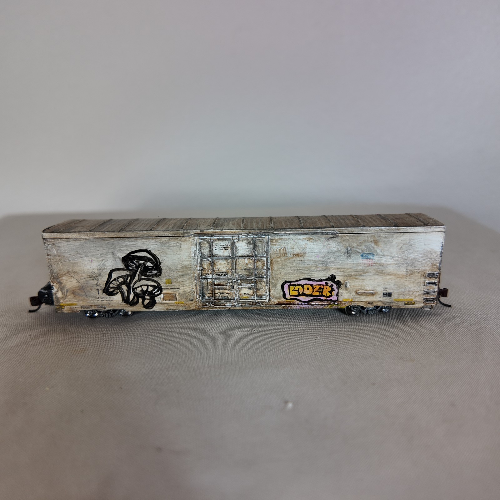 N-scale hand-painted tagged and weathered boxcar