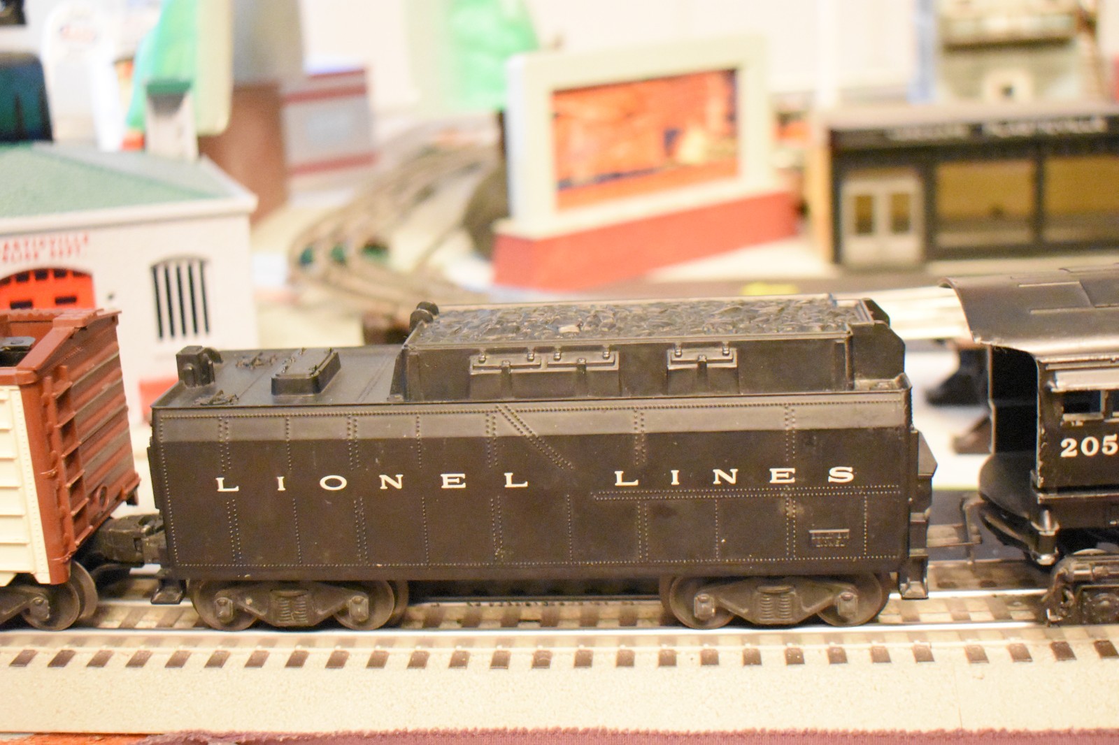 Lionel 2055 steam locomotive & 6026W Tender and 3 rolling stock cars.